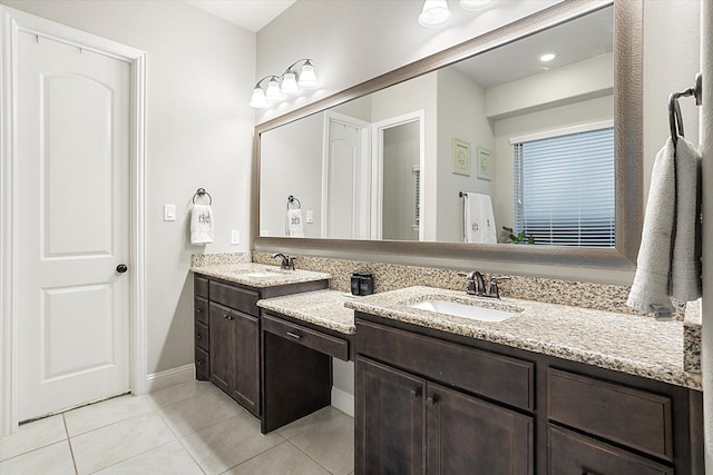 bathroom with double vanity, a sink, and tile patterned floors