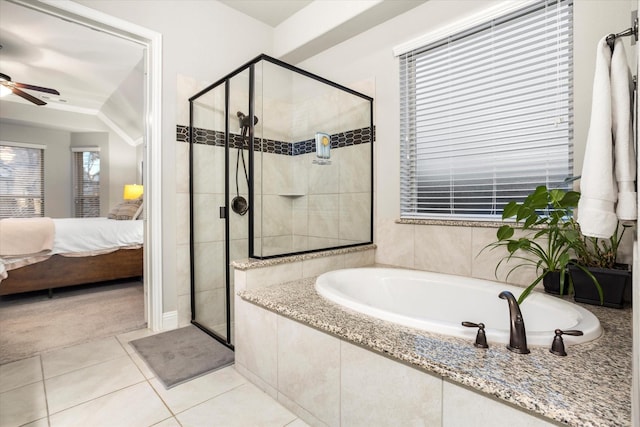 ensuite bathroom featuring tile patterned floors, ensuite bath, a bath, and a shower stall