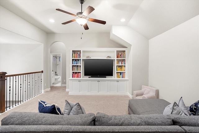 living room featuring arched walkways, lofted ceiling, recessed lighting, a ceiling fan, and light carpet