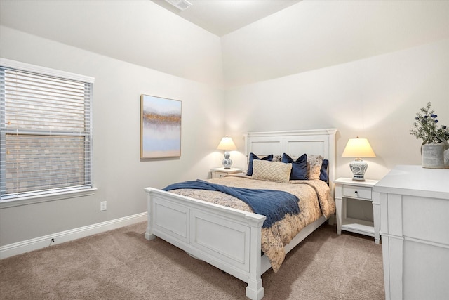 bedroom featuring light carpet and baseboards