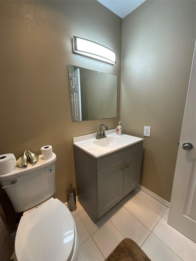 bathroom with tile patterned flooring, vanity, and toilet