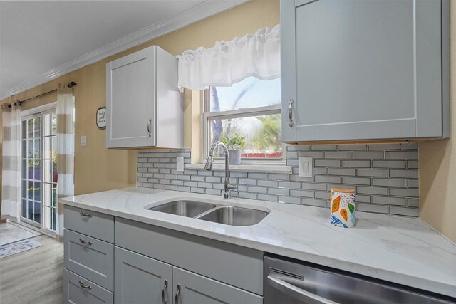 interior details featuring decorative backsplash, light countertops, and a sink