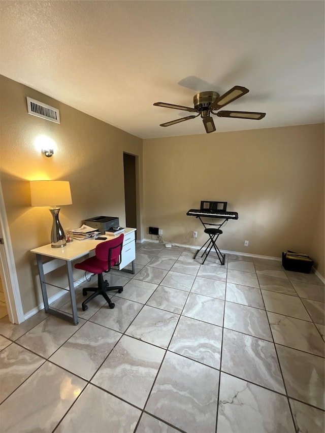 office space featuring visible vents, ceiling fan, and baseboards