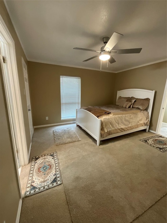 bedroom with ceiling fan, baseboards, carpet flooring, and crown molding