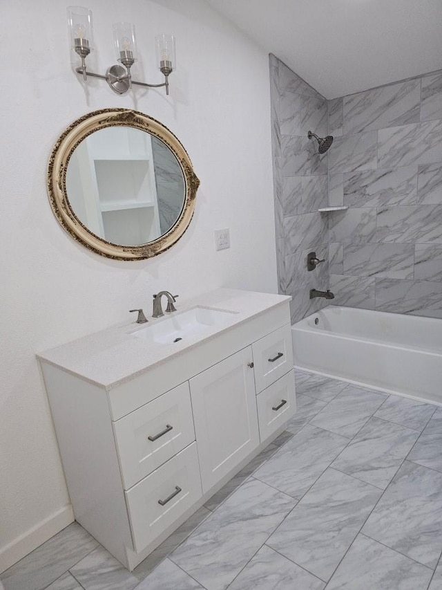 bathroom featuring marble finish floor, shower / bathing tub combination, and vanity