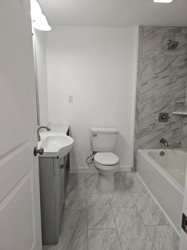 bathroom featuring toilet, marble finish floor, vanity, and baseboards