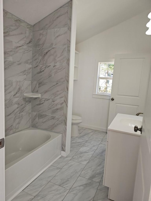 full bath featuring lofted ceiling, marble finish floor, vanity, and toilet