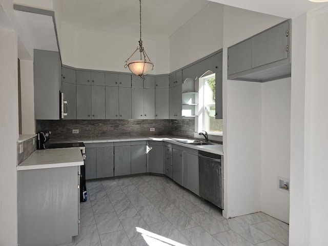 kitchen with stainless steel appliances, marble finish floor, a sink, and gray cabinetry