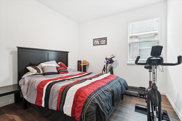 bedroom featuring baseboards and wood finished floors