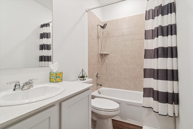 full bathroom with vanity, wood finished floors, shower / bath combo with shower curtain, and toilet