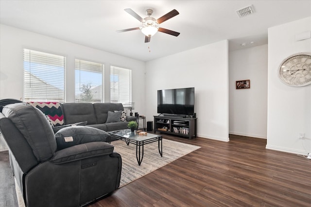 living area with a ceiling fan, dark wood-style flooring, visible vents, and baseboards