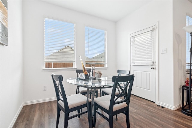 dining area with baseboards and wood finished floors