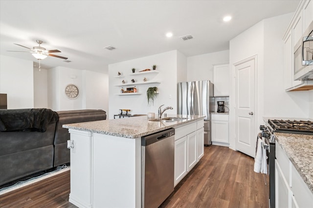 kitchen featuring appliances with stainless steel finishes, dark wood-style flooring, visible vents, and a sink