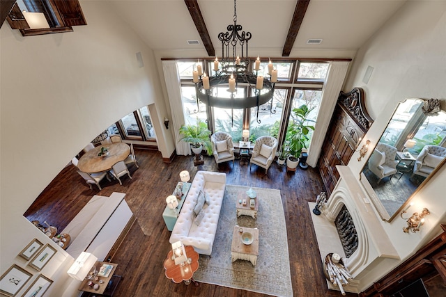 140 Manor Dr, Heath, TX 75032 - living room featuring a chandelier, wood finished floors, arched walkways, beamed ceiling, and a towering ceiling