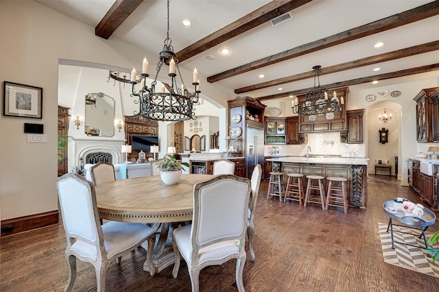 140 Manor Dr, Heath, TX 75032 - dining space with arched walkways, a chandelier, recessed lighting, dark wood finished floors, and beamed ceiling