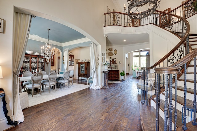 140 Manor Dr, Heath, TX 75032 - foyer entrance featuring a chandelier, arched walkways, a towering ceiling, ornamental molding, and stairway