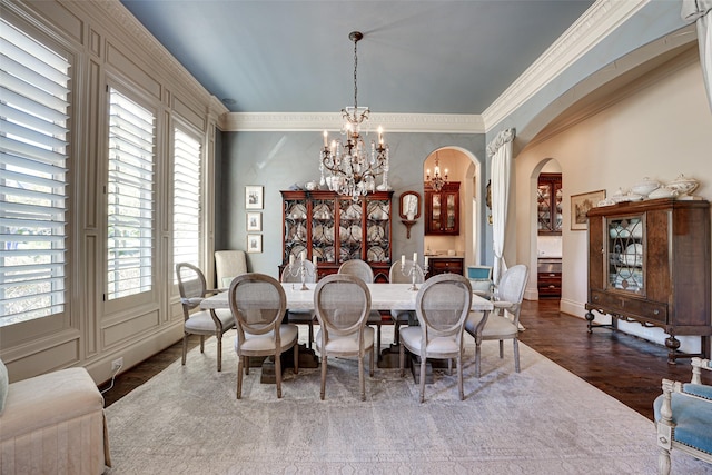 140 Manor Dr, Heath, TX 75032 - dining area featuring a chandelier, arched walkways, ornamental molding, dark wood-style flooring, and baseboards