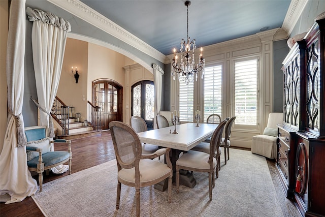 140 Manor Dr, Heath, TX 75032 - dining area with arched walkways, a chandelier, plenty of natural light, stairs, and crown molding