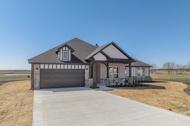 view of front of house with brick siding, a porch, roof with shingles, a garage, and driveway