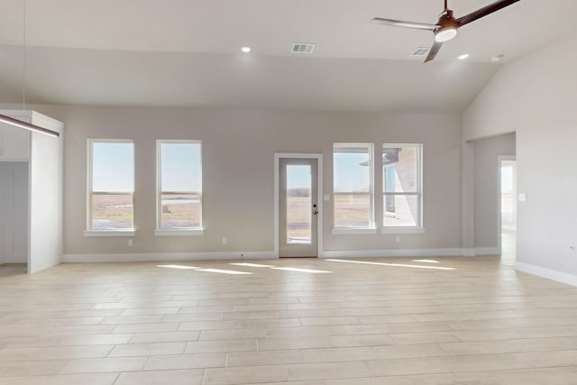 unfurnished living room with lofted ceiling, a healthy amount of sunlight, baseboards, and ceiling fan