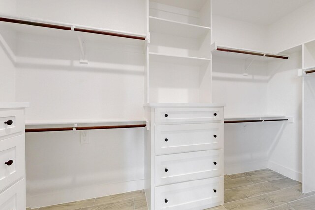 walk in closet featuring wood tiled floor