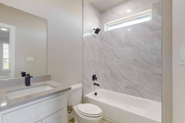 bathroom with shower / bathtub combination, toilet, and vanity