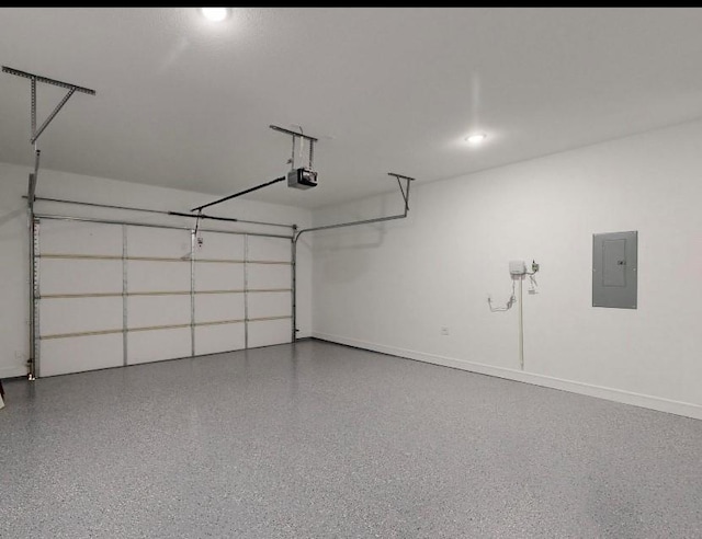 garage with electric panel, a garage door opener, and baseboards