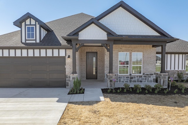 view of front of home featuring brick siding, a porch, roof with shingles, a garage, and driveway