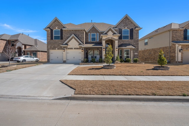 traditional-style home with concrete driveway, brick siding, and an attached garage