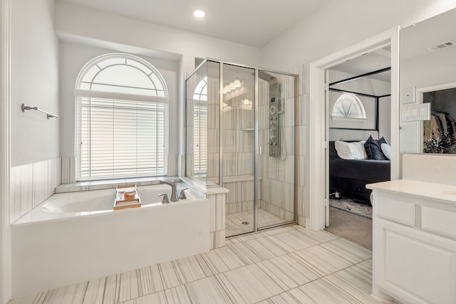 bathroom featuring a stall shower, plenty of natural light, a garden tub, and visible vents
