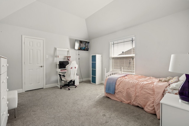 carpeted bedroom featuring lofted ceiling and baseboards