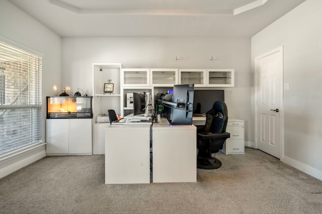 office with a raised ceiling, light colored carpet, and baseboards
