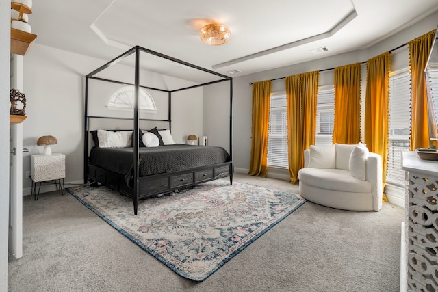 carpeted bedroom featuring baseboards and visible vents