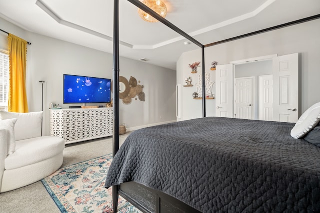 bedroom featuring carpet floors, a tray ceiling, and visible vents
