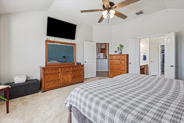 bedroom with visible vents, ceiling fan, vaulted ceiling, light carpet, and ensuite bath