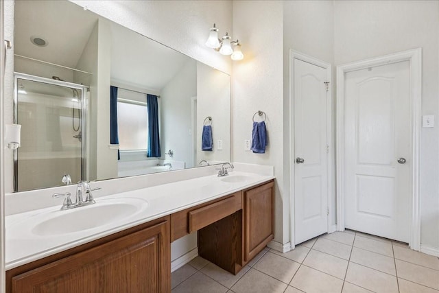 bathroom with tile patterned flooring, a shower stall, and a sink