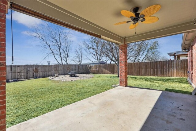 view of patio / terrace featuring a fenced backyard, a fire pit, and ceiling fan