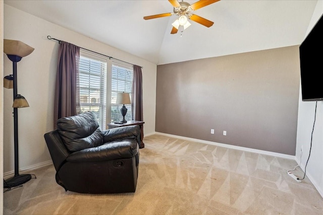 sitting room with lofted ceiling, light colored carpet, baseboards, and ceiling fan