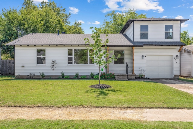 view of front of house featuring an attached garage, concrete driveway, roof with shingles, and a front yard