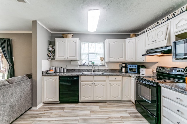 kitchen featuring under cabinet range hood, a sink, black appliances, tasteful backsplash, and dark countertops