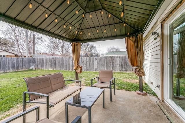 view of patio featuring a gazebo, outdoor lounge area, and a fenced backyard