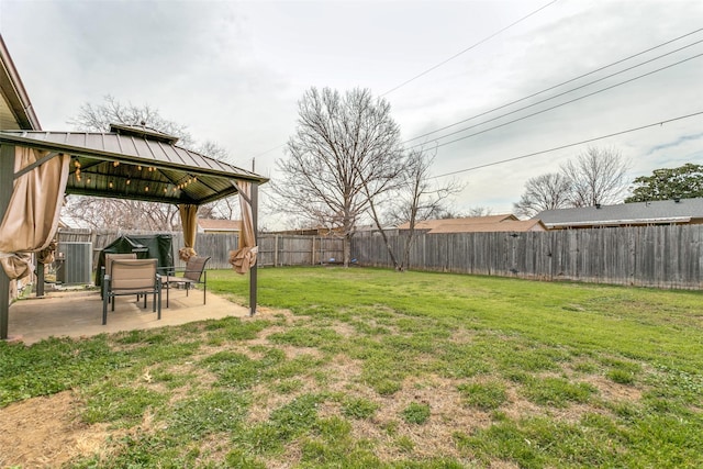 view of yard with central AC, a patio area, a fenced backyard, and a gazebo