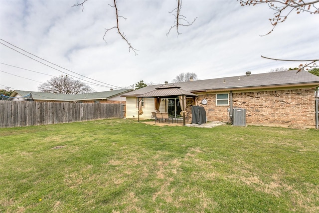 rear view of house with central AC unit, a lawn, a patio, fence, and a gazebo