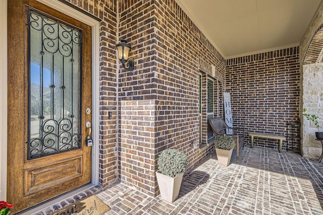 property entrance featuring brick siding