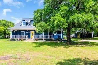 view of front of property with a porch and a front lawn