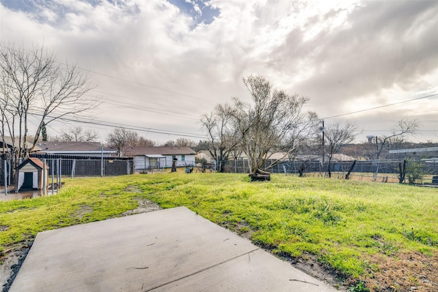 view of yard with an outdoor structure and fence