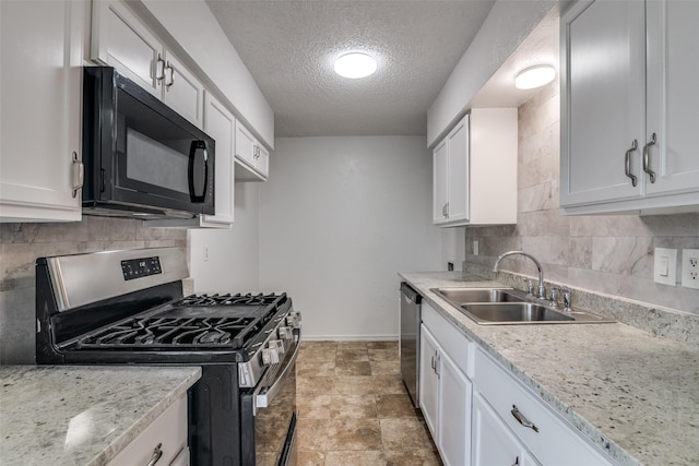 kitchen featuring tasteful backsplash, a textured ceiling, stainless steel appliances, and a sink