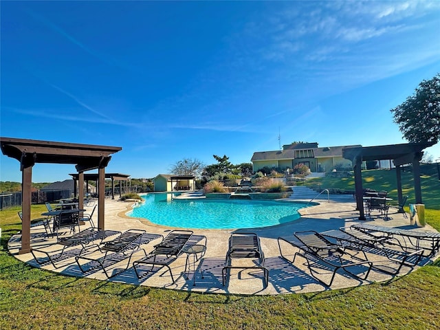 community pool with a patio, a lawn, and fence