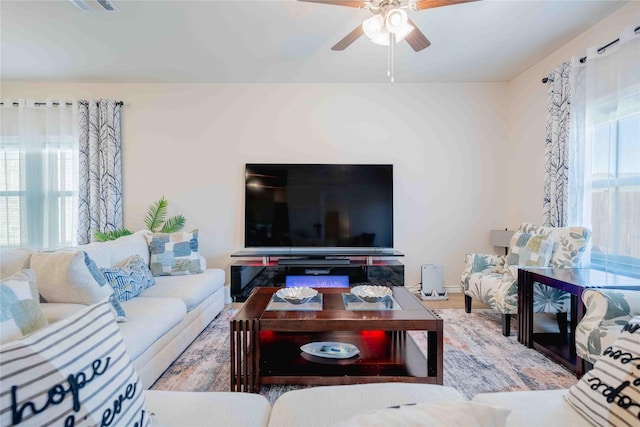 living room featuring plenty of natural light and ceiling fan