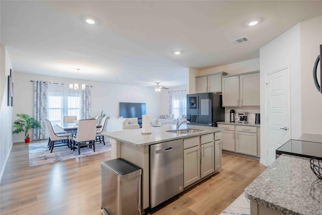 kitchen with freestanding refrigerator, gray cabinets, visible vents, and stainless steel dishwasher